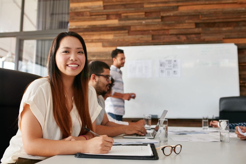 7 asian woman smiling during business presentation P2TRSSV